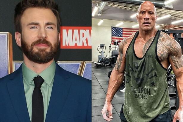 Chris Evans, vestido de terno azul, e Dwayne Johnson, vestido de camiseta