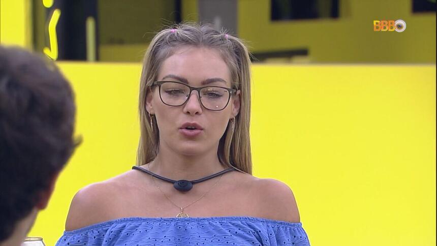 Bárbara de blusa azul sentada na mesa do Almoço do Anjo do BBB 22