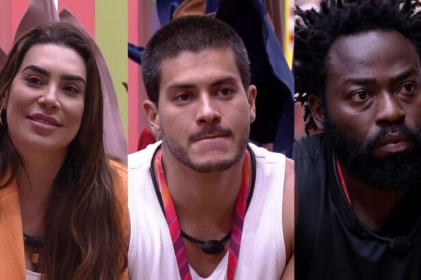 Naiara Azevedo sorrindo, Arthur Aguiar sério e Douglas Silva com semblante assustado após a formação do terceiro paredão do BBB 22