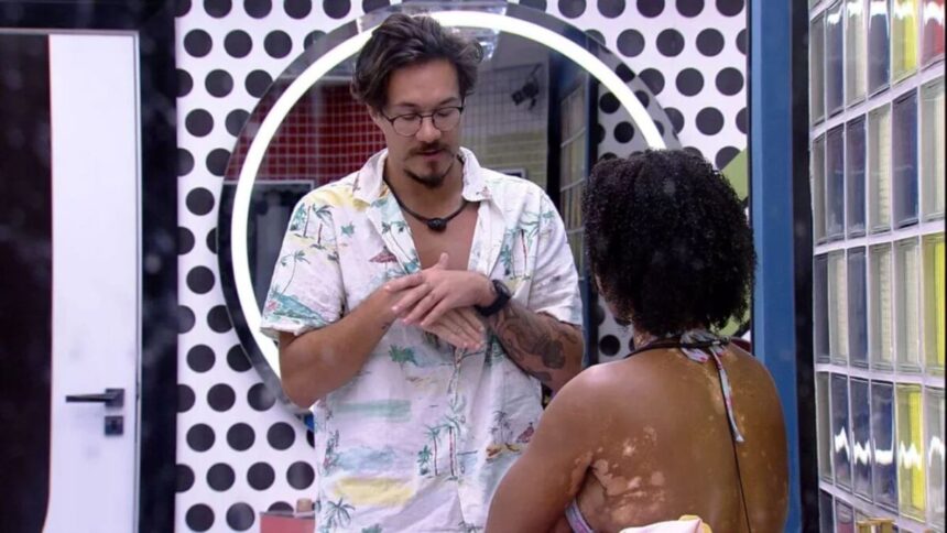 Eliezer em pé conversa com Natália