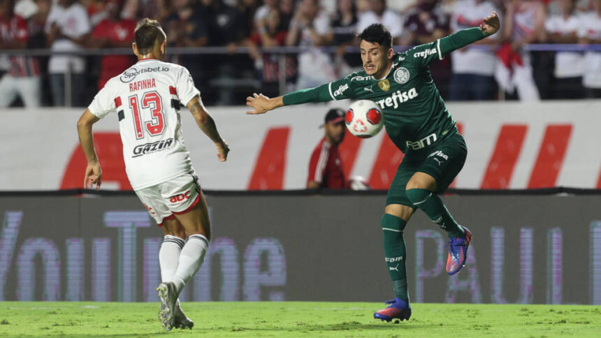 Jogadores de São Paulo e Palmeiras em campo, disputando uma bola, pela final do Paulistão