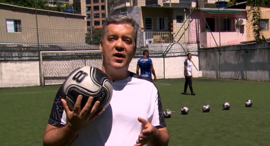 Roberto Kovalick com uma bola de futebol na mão durante trecho de reportagem para o Hora 1