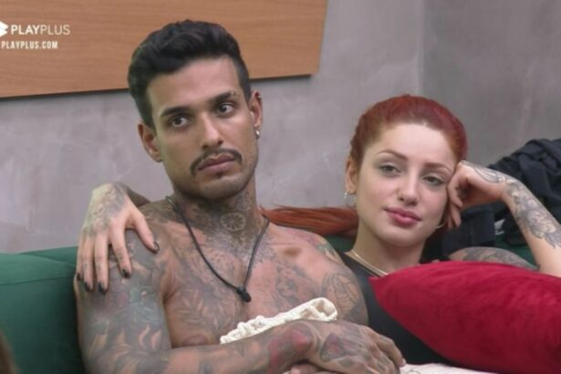 Matheus sem camisa ao lado de Brenda no sofá do Power Couple.