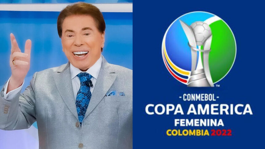 Silvio Santos sorrindo, de palitó cinza, lenço azul no bolso, com a mão pra cima e gravata azul com preto durante gravação de seu programa; Logo oficial da Copa América Feminina 2022