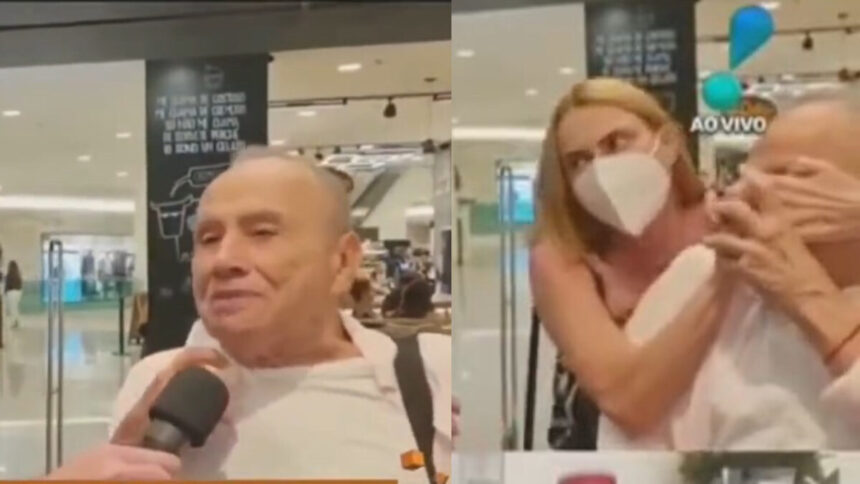 Esposa de Stênio Garcia em aeroporto tapando pondo a máscara durante entrevista para a RedeTV!