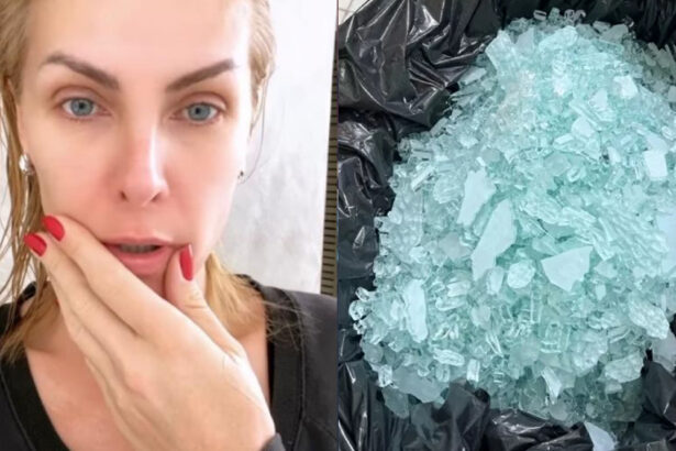 Ana Hickmann com sembrante assustado, unha vermelha, camisa preta, cabelo molhado, com a mão na boca durante gravação de storys para instagram; saco plástico preto com pedaços de vidro