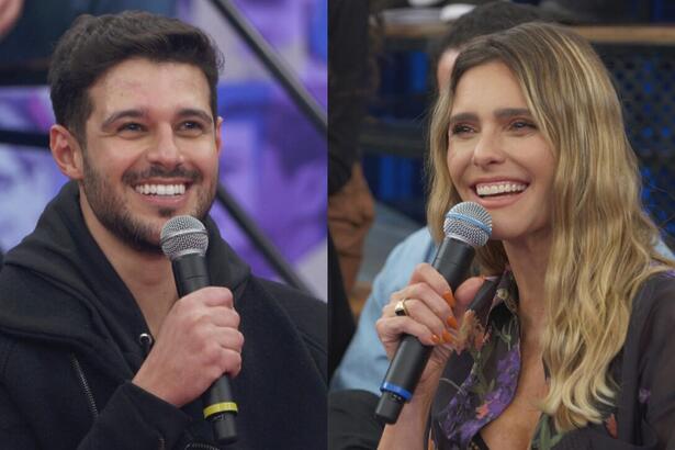 Rodrigo Mussi de camisa preta, segurando o microfone co a mão direita, sorrindo, sentado, durante entrevista no Altas Horas; Fernanda Lima com camisa estampada em tons de lilás e magenta, sorrindo, segurando o microfone com a mão esquerda