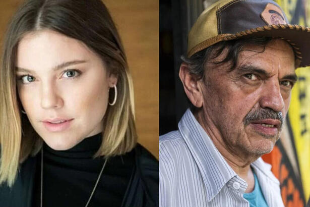 Alice Wegmann de camisa preta e colar de prata; José Dumont de camisa social azul claro e chapéu