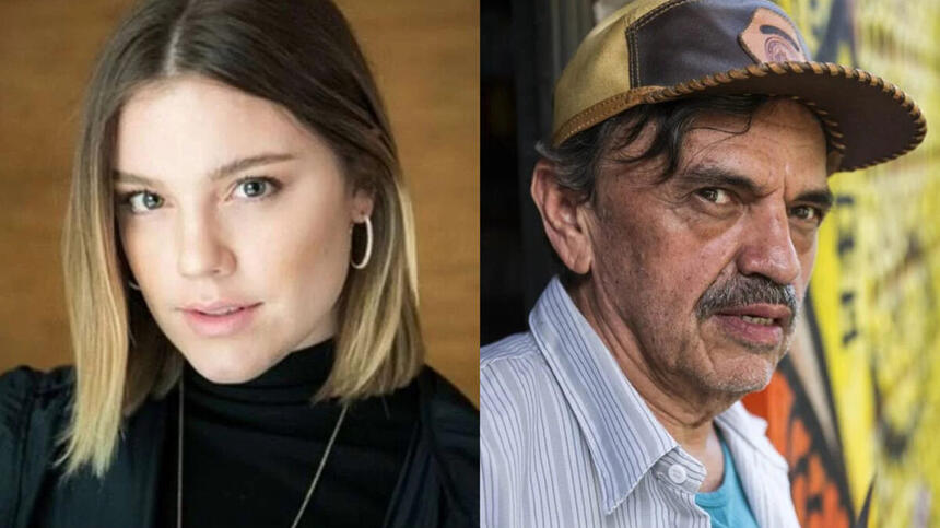 Alice Wegmann de camisa preta e colar de prata; José Dumont de camisa social azul claro e chapéu