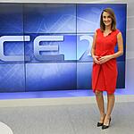 Patricia Nielsen de vestido vermelho em frente ao telão do CETV 2ª edição