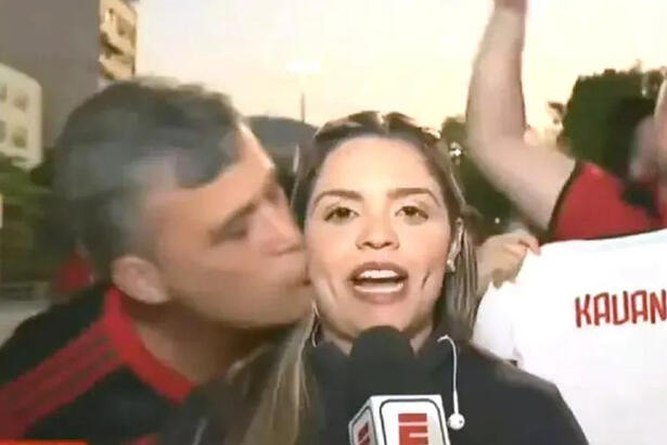 Repórter Jéssica Dias sendo beijada no rosto por um torcedor do Flamengo durante entrada ao vivo na ESPN