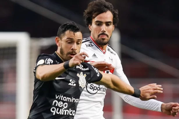 Jogadores de São Paulo e Corinthians disputando bola em jogo do Brasileirão
