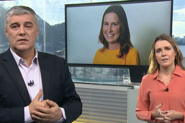 Flavio Fachel e Silvana Ramiro, no estúdio do Bom Dia RJ, com uma imagem de Susana Naspoli no televisor ao fundo