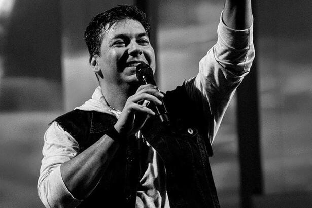 Sérgio Missão em trecho de um show pela banda, em uma foto em preto e branco