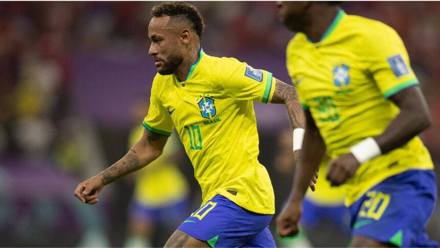 Neymar, com a camisa da Seleção Brasileira, em campo contra a Sérvia, ao lado de outro jogador