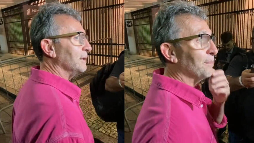 Neto vestido uma blusa rosa, em trechos da entrevista na porta da Vila Belmiro