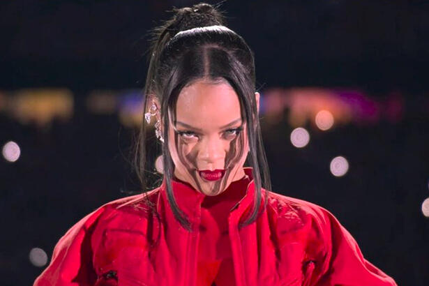 Rihanna de sobretudo e calça vermelha durante apresentação no Super Bowl