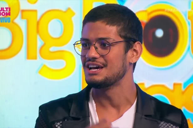 Gabriel Santana de jaqueta preta, camisa branca, oculos de grau durante gravação para o Multishow