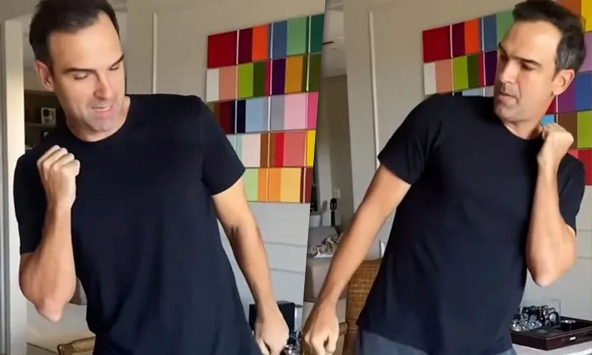 Tadeu Schmidt de camisa preta dançando durante gravação de vídeo