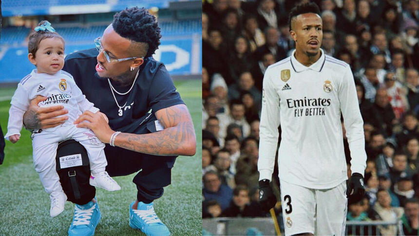 Éder Militão posando com a pequena Cecilia no colo, no gramado do estádio do Real Madrid