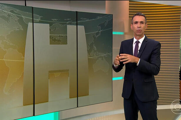 Cesar Tralli em frente ao telão, no estúdio do Jornal Hoje