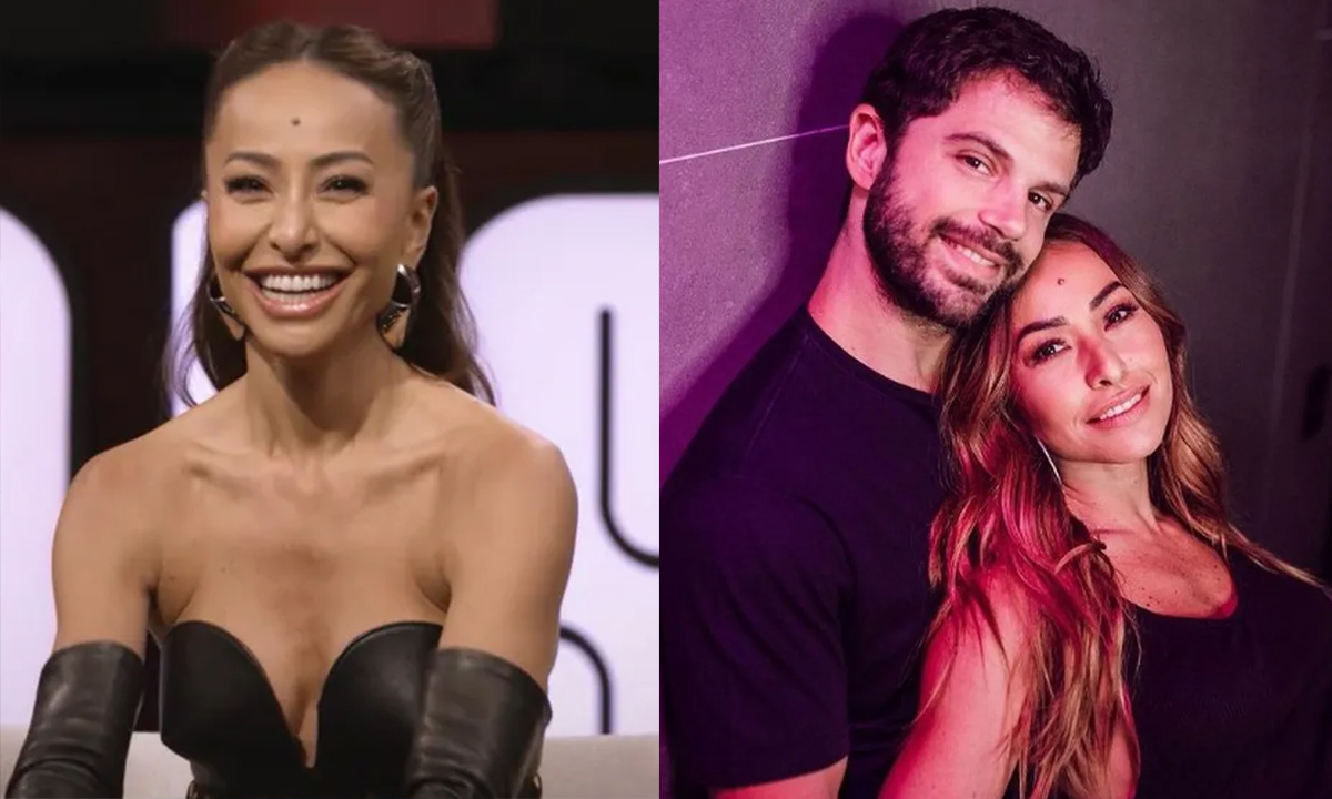 Sabrina Sato sorrindo, de cabelo penteado, vestido preto, sentada durante gravação do Sobre Nós Dois; Imagem 2: Duda Nage de camisa preta, sentado no chão, abraçado com Sabrina Sato