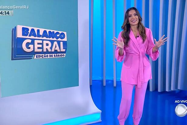 Paloma Poeta de conjunto rosa, sorridente apresentando o Balanço Geral RJ - Edição de sábado, ao vivo