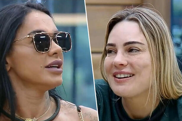 Simioni de óculos escuro e Rachel Sheherazade na cozinha de A Fazenda, ambas estão sorrindo