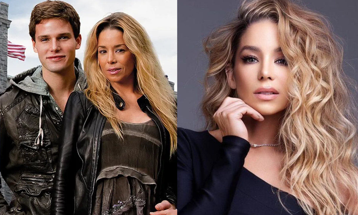 Imagem 1: Danielle Winits de casado e vestido preto, cabelo solto, abraçada por traz por Jõnatas Faro