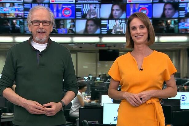 Nélson Araújo de camisa verde e Helen Martins de vestido laranja apresentando o Globo Rural