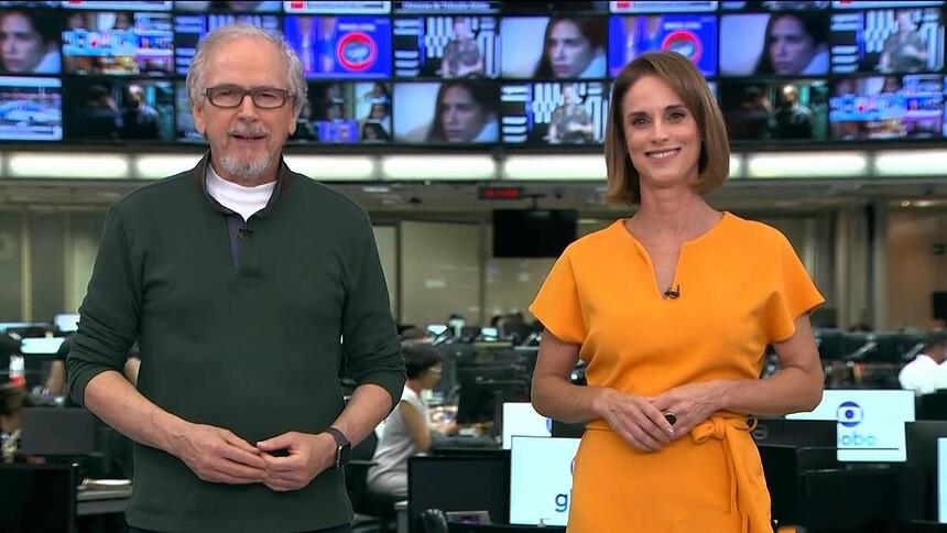 Nélson Araújo de camisa verde e Helen Martins de vestido laranja apresentando o Globo Rural