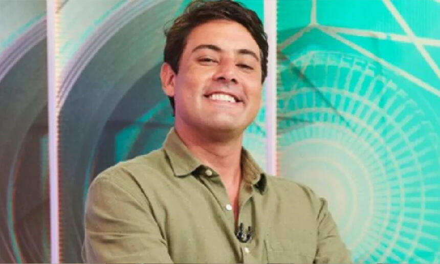 Bruno de Luca com camisa social verde, sorrindo, durante gravação de programa no Multishow