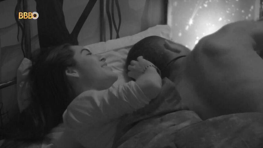 Isabelle e Davi deitadas na cama, com ela passando a mão no cabelo dele no BBB 24