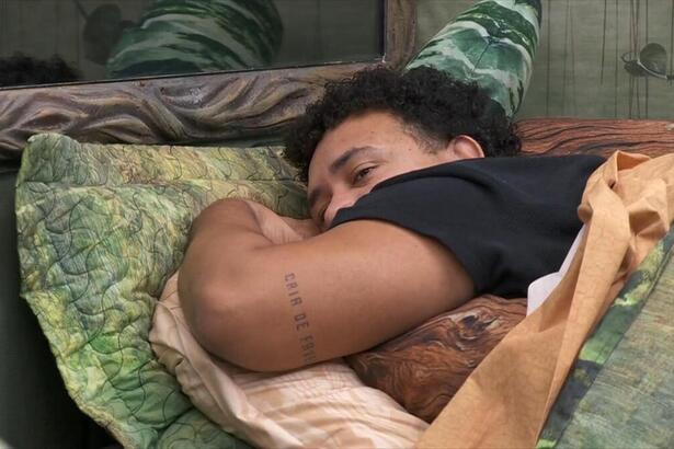 Lucas deitado na cama de Rodriguinho no Quarto Gnomo do BBB 24