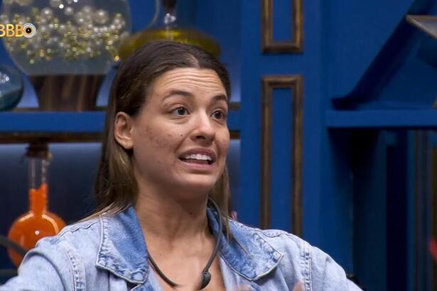 Beatriz faz gestos com as mãos como que tem fogo ao pedir votos na sala do BBB 24