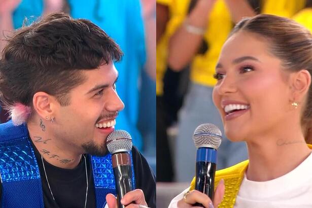 Zé Felipe com o colete Azul e Virginia Fonseca com o colete amarelo do Passa ou Repassa no Domingo Legal. Ambos estão sorridentes