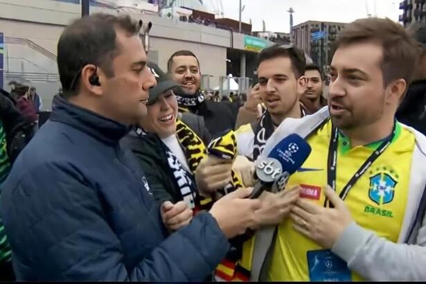 O repórter André Galvão entrevistando torcedores na porta do estádio de Wembley, em Londres