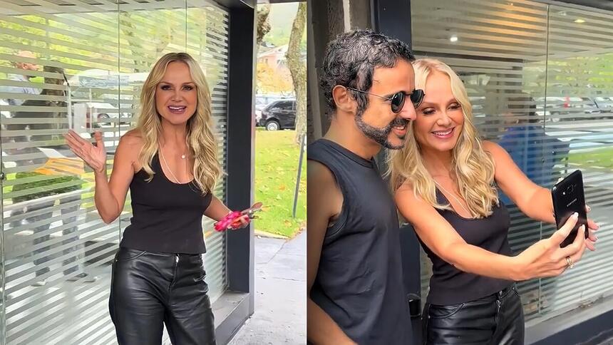 Eliana chega na entrada da TV Globo, acena e tira foto ao lado de fã