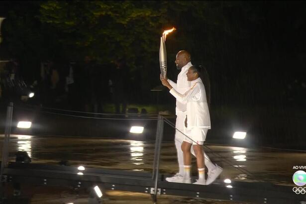 Teddy Riner e Marie-José Pérec acendendo a pira olímpica em Paris 2024