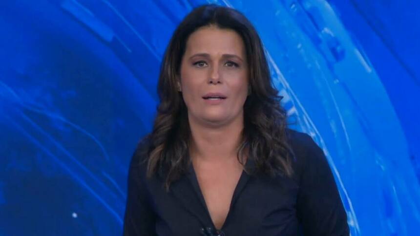 Adriana Araújo com semblante sereno na bancada do Jornal da Band