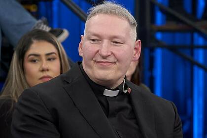 Padre Marcelo Rossi sentado, de batina, participando do programa Altas Horas