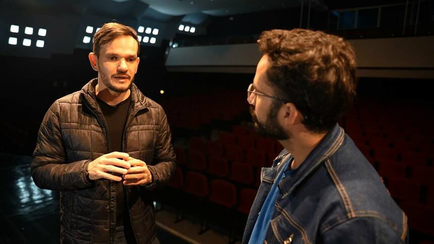 Repórter Guilherme Machado entrevistando o Padre Patrick no programa Arquivo A