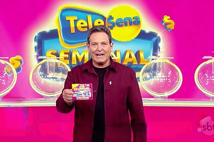 Luiz Ricardo segura o bilhete da Tele Sena Semanal edição 28 na cor rosa