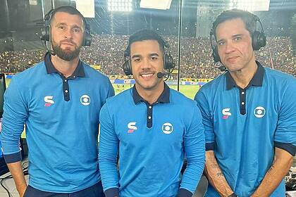 Dênis Medeiros e os comentaristas Cabral Neto e Danny Morais posando com o uniforme da Globo