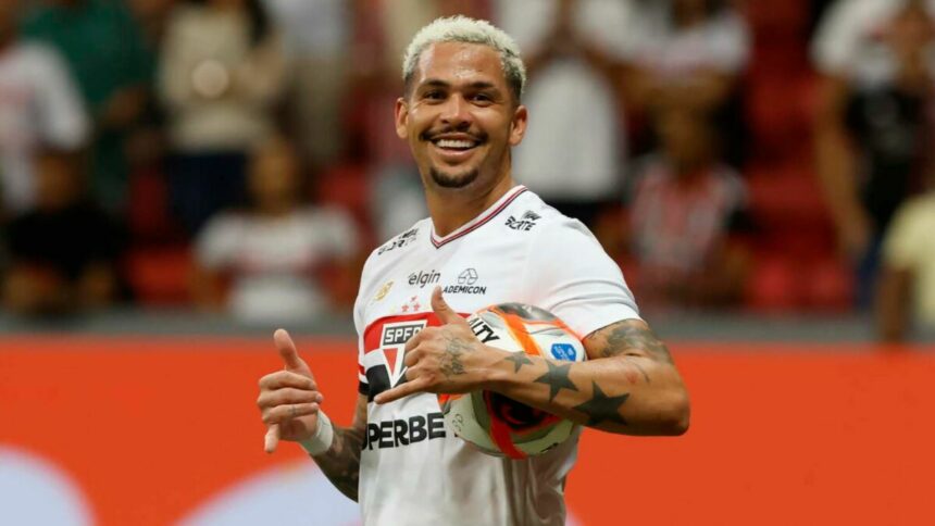 Jogador Luciano, com uma bola embaixo do braço, com a camisa do São Paulo