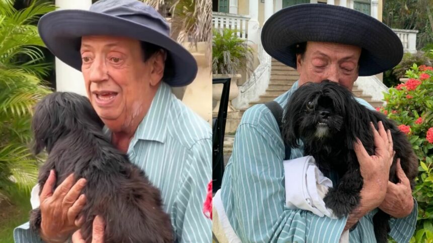 Marcos Oliveira, com a cachorrinha no colo, na chegada ao Retiro dos Artistas