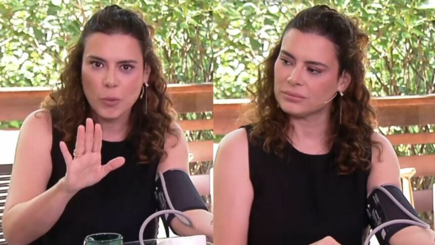 Michelle Loreto com o aparelho de aferir pressão no braço, em trecho do Bem Estar no É de Casa