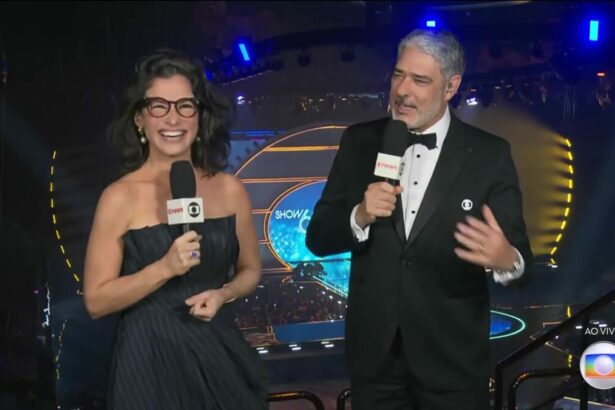 Renata Vasconcellos e William Bonner apresentando o Jornal Nacional na arquibancada do Show 60 anos da TV Globo