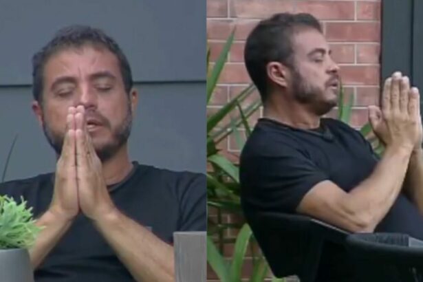Dhomini com os olhos cerrados e as mãos fechadas, fazendo uma oração no Power Couple