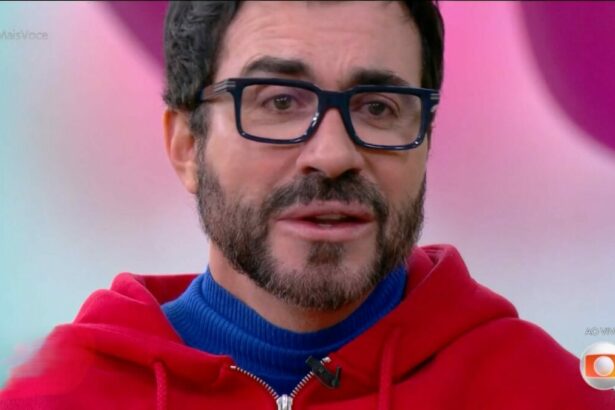 Padre Fábio de Melo com camisa azul e casaco vermelho chorando no Mais Você